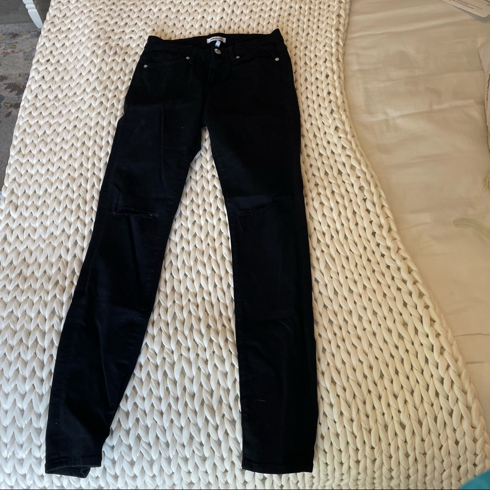 Good American black skinny jeans with ripped knees